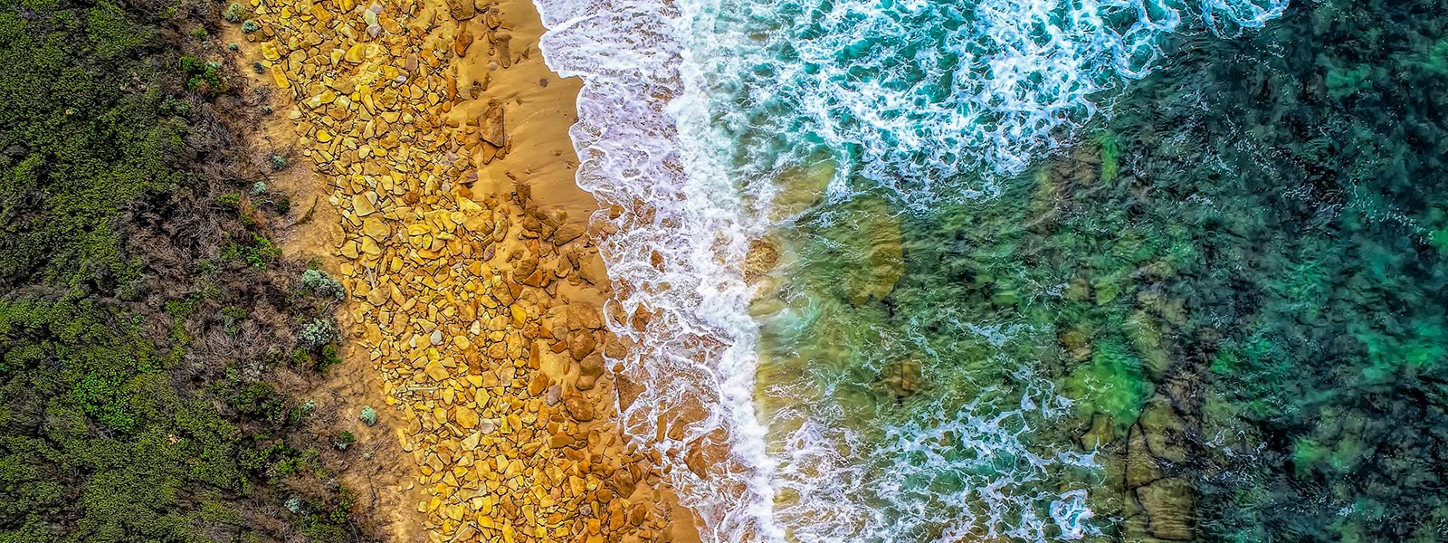 Ariel image of bush rocks and ocean