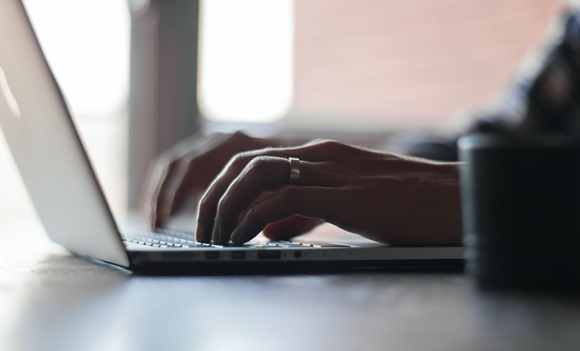 Image of hands typing on laptop