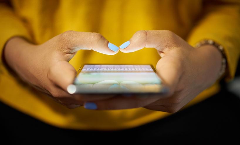 Image of women typing on mobile phone